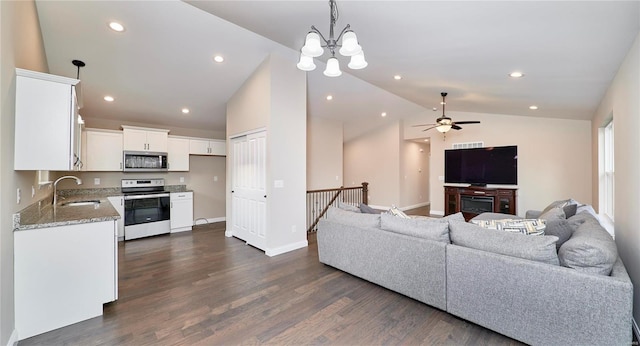 living area featuring dark wood finished floors, recessed lighting, baseboards, and lofted ceiling