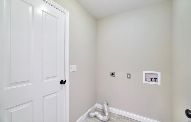 laundry area with laundry area, hookup for a washing machine, hookup for an electric dryer, and baseboards