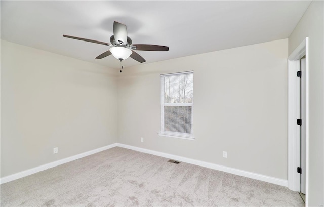 empty room featuring visible vents, a ceiling fan, carpet, and baseboards