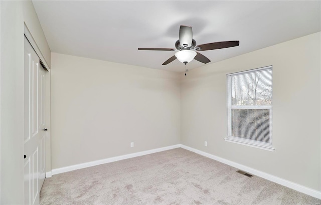 unfurnished bedroom with visible vents, carpet flooring, baseboards, and a closet