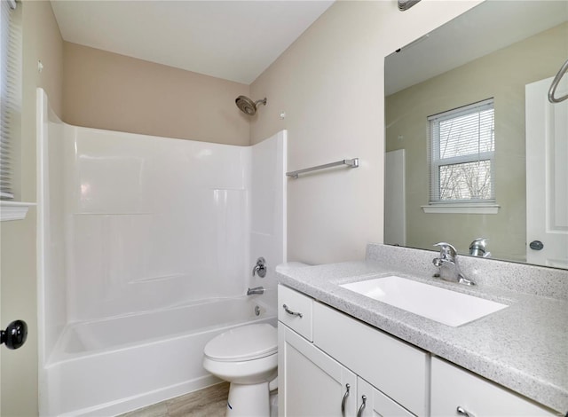 bathroom featuring vanity, toilet, and shower / bathtub combination