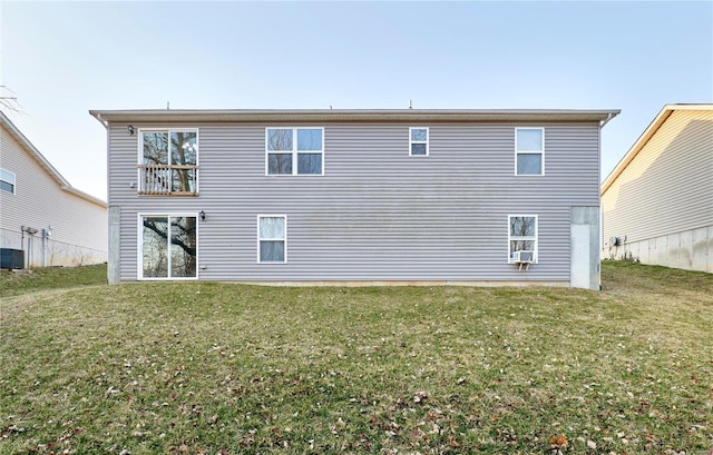 rear view of property with a lawn and central AC unit