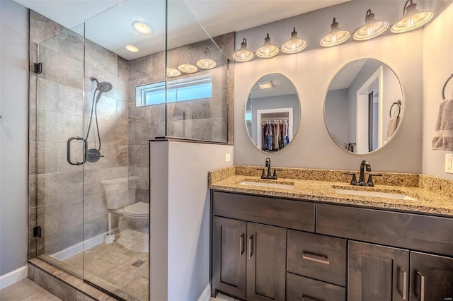 full bath featuring a sink, a stall shower, and double vanity