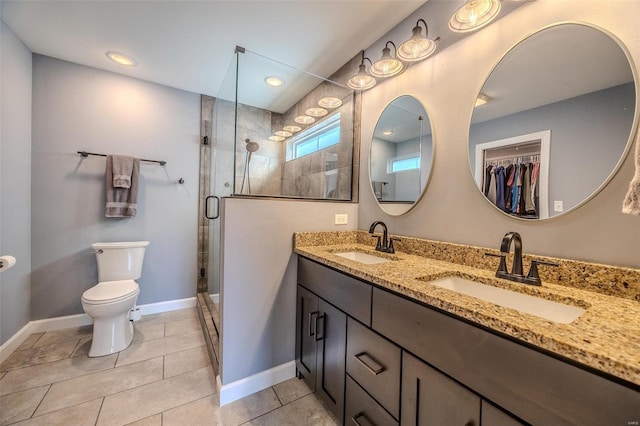 full bath featuring a sink, baseboards, toilet, and a shower stall