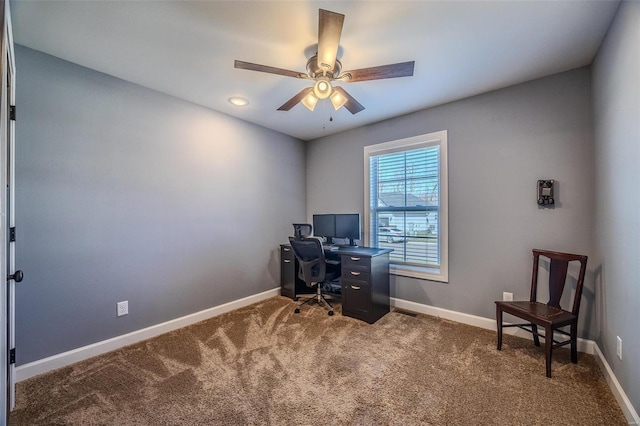 carpeted office featuring ceiling fan and baseboards