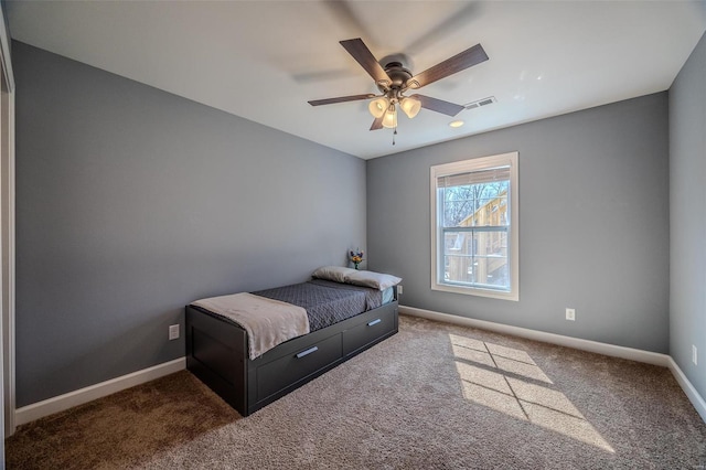 carpeted bedroom featuring a ceiling fan, baseboards, and visible vents