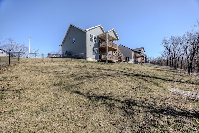 view of side of home with stairway, a yard, a fenced backyard, and a wooden deck