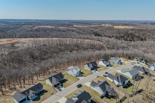 birds eye view of property with a residential view and a wooded view