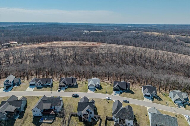 birds eye view of property featuring a forest view and a residential view