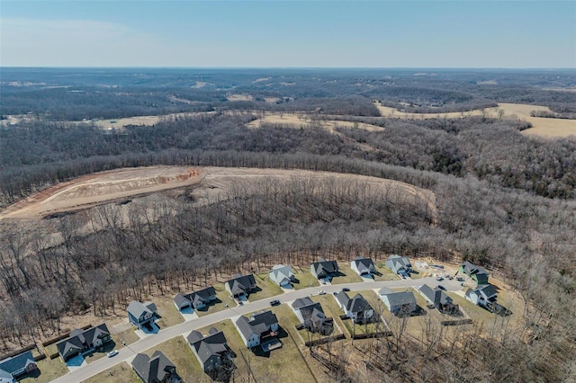 birds eye view of property with a wooded view and a residential view