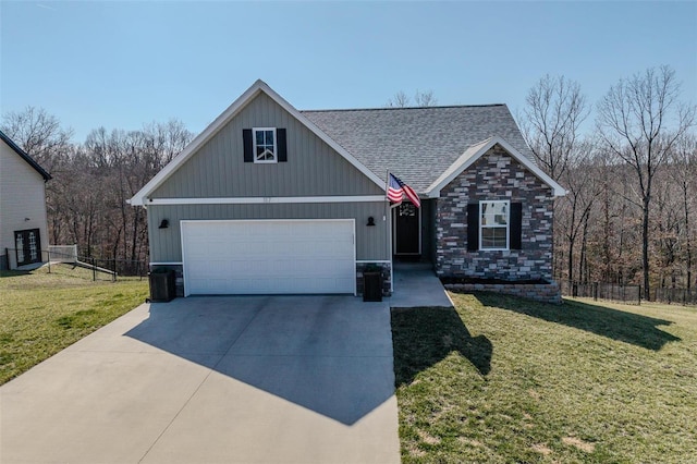 view of front of home featuring a front yard, an attached garage, fence, and concrete driveway