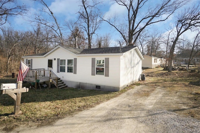 view of front of house featuring crawl space and driveway