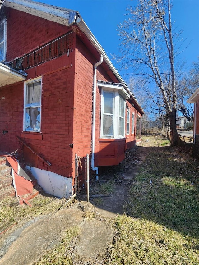 view of side of property with brick siding