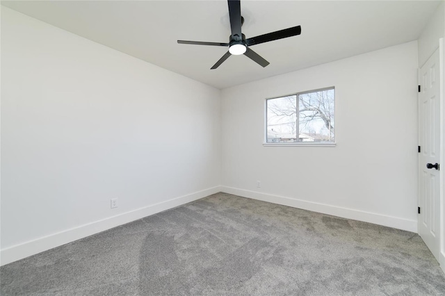 spare room with carpet flooring, ceiling fan, and baseboards