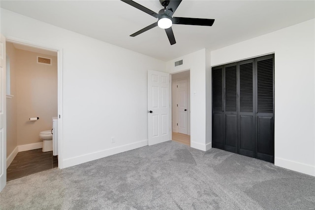 unfurnished bedroom with visible vents, baseboards, a closet, and carpet flooring