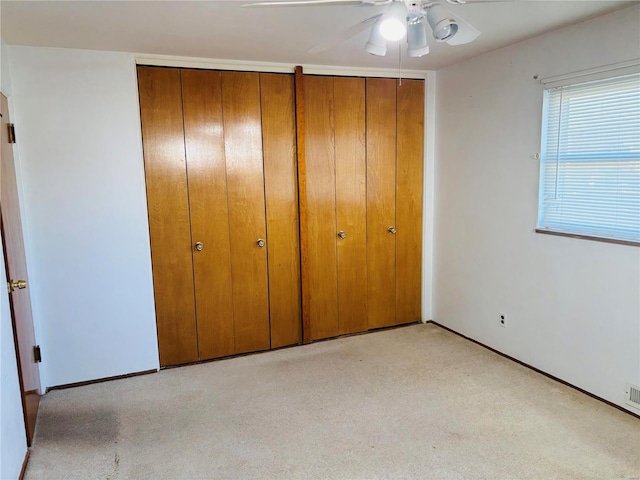 unfurnished bedroom with ceiling fan and carpet floors