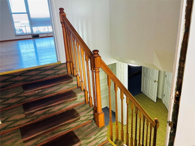 staircase featuring visible vents and carpet flooring