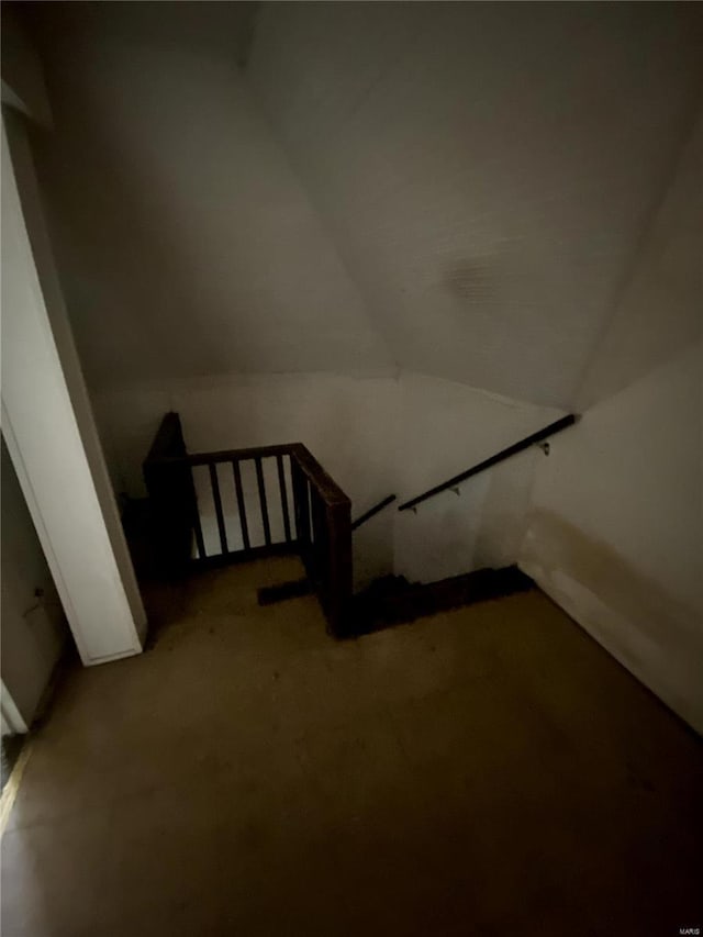 staircase featuring vaulted ceiling