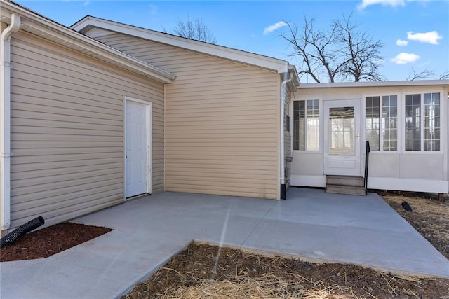 entrance to property with a patio