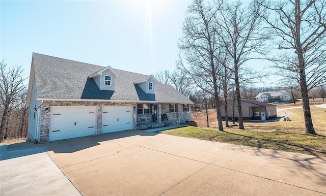 cape cod house featuring driveway, a front yard, roof with shingles, and an attached garage