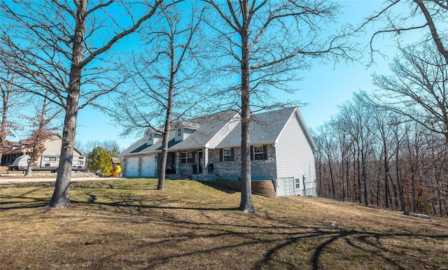 view of front of home featuring an attached garage and a front yard