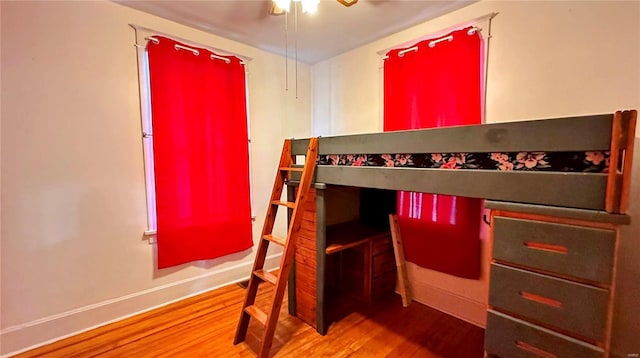 bedroom with wood finished floors and baseboards