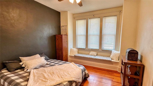 bedroom featuring baseboards, ceiling fan, and hardwood / wood-style flooring