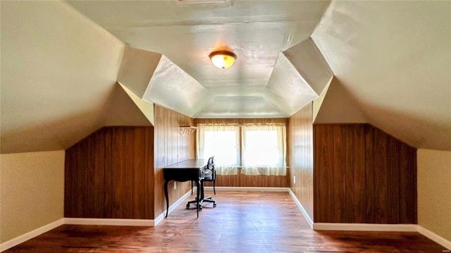 office with wooden walls, baseboards, lofted ceiling, and wood finished floors