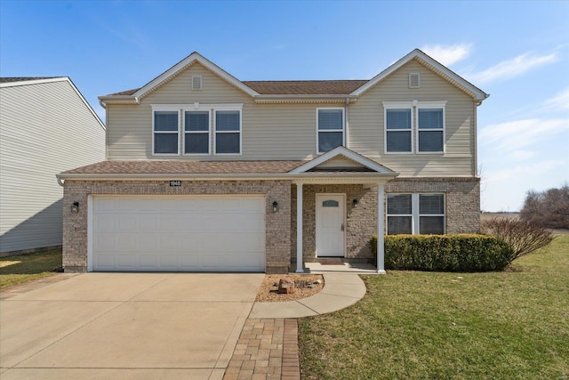 view of front of house featuring brick siding, an attached garage, concrete driveway, and a front lawn