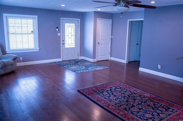 foyer entrance with baseboards, wood finished floors, and ceiling fan