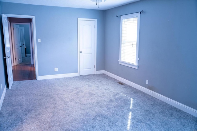 unfurnished bedroom with visible vents, baseboards, and carpet floors