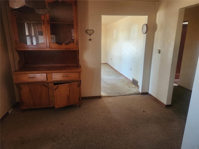 interior space featuring carpet, visible vents, and baseboards