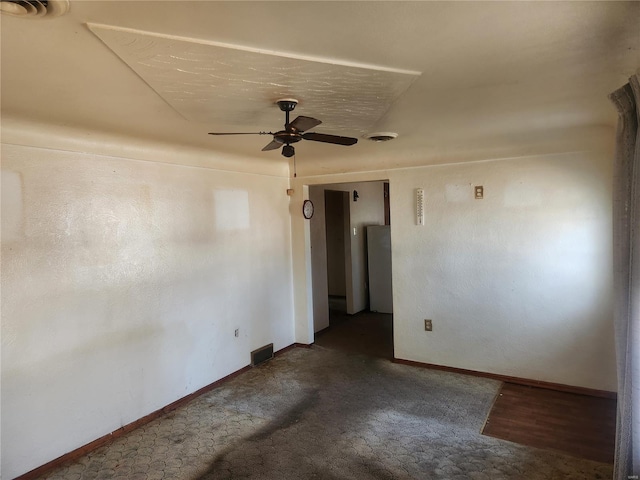 spare room featuring visible vents, baseboards, and a ceiling fan