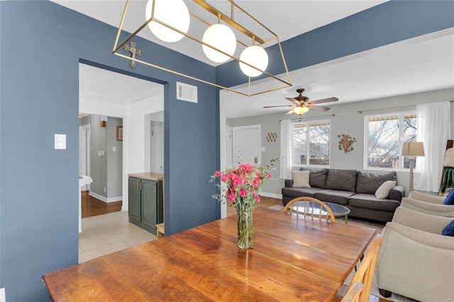 dining space featuring light tile patterned floors, baseboards, visible vents, and ceiling fan