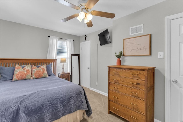 bedroom with light carpet, visible vents, a ceiling fan, and baseboards