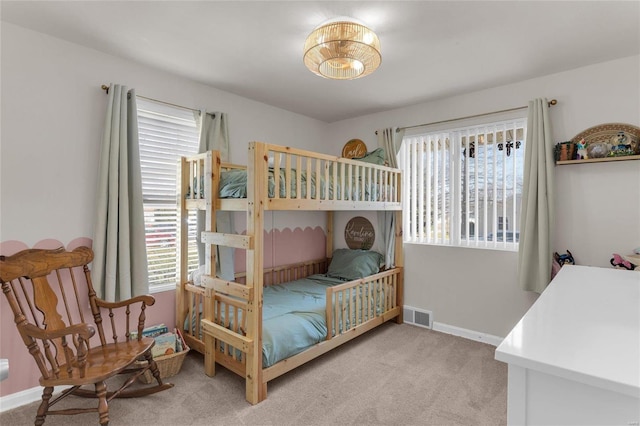 carpeted bedroom with visible vents and baseboards