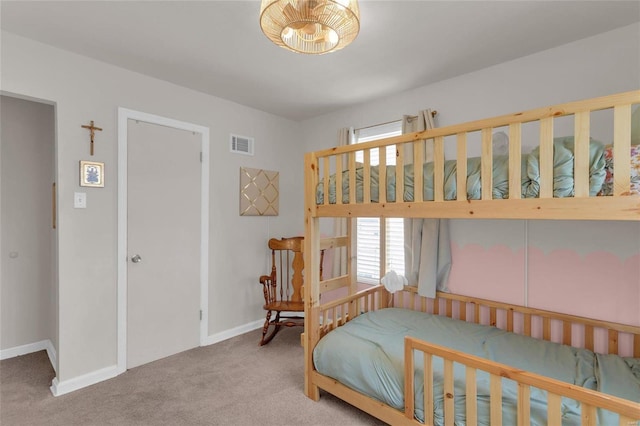 carpeted bedroom featuring baseboards and visible vents