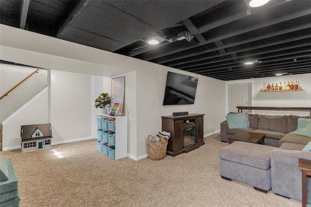 carpeted living room featuring baseboards