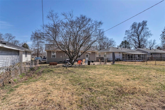 view of yard featuring a patio area, fence, and a fire pit