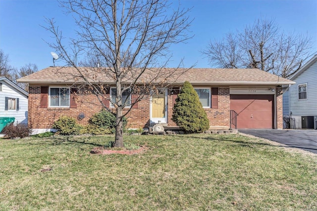 single story home featuring aphalt driveway, a garage, brick siding, and a front yard