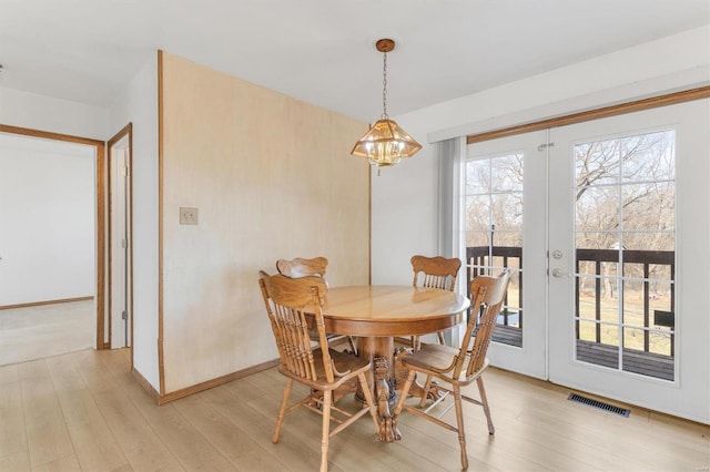 dining area with visible vents, french doors, baseboards, and light wood-style floors