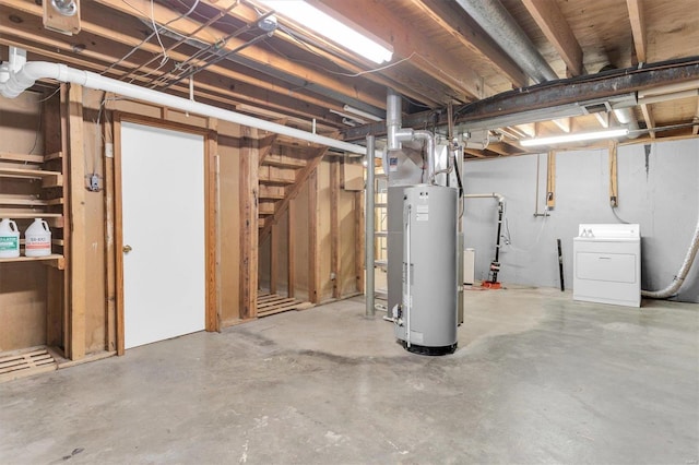 unfinished basement featuring gas water heater and washer / clothes dryer