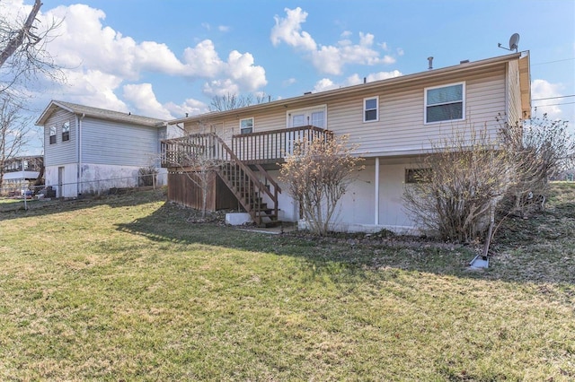 rear view of property with a yard, a wooden deck, stairs, and fence