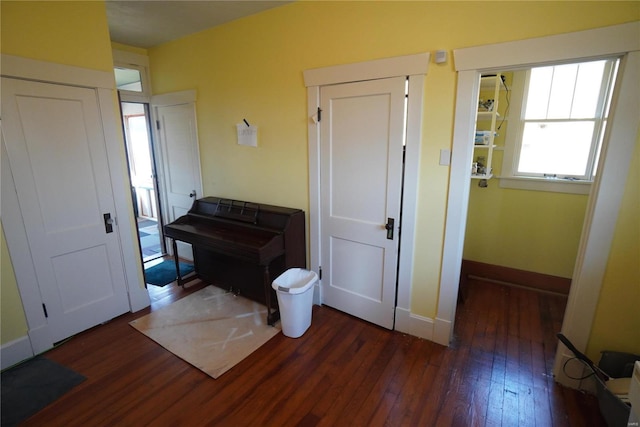 entrance foyer with baseboards and hardwood / wood-style flooring