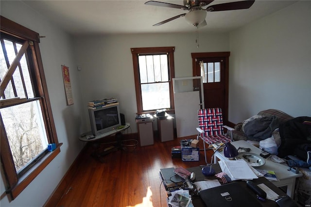 living area featuring wood finished floors and a ceiling fan