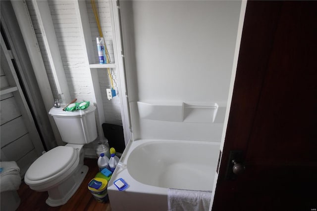 bathroom featuring a tub and toilet