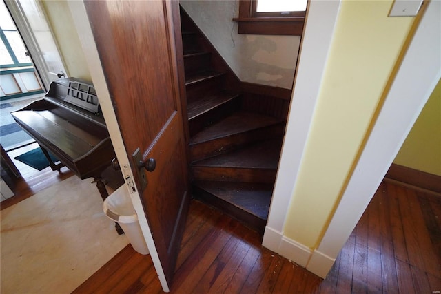 staircase featuring baseboards and hardwood / wood-style flooring