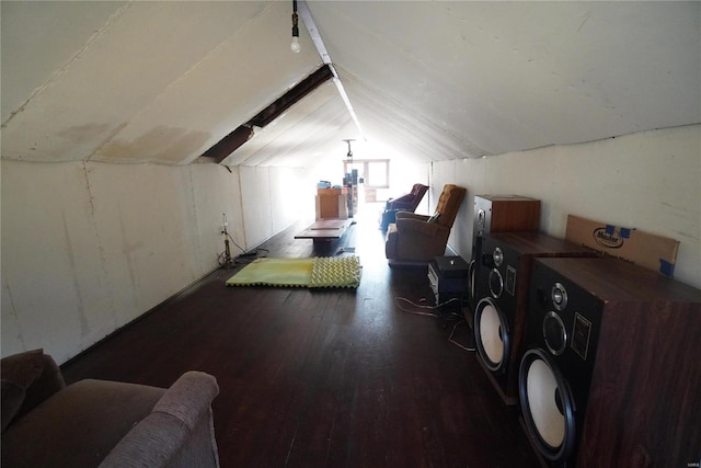 additional living space with washer and dryer, vaulted ceiling, and wood-type flooring