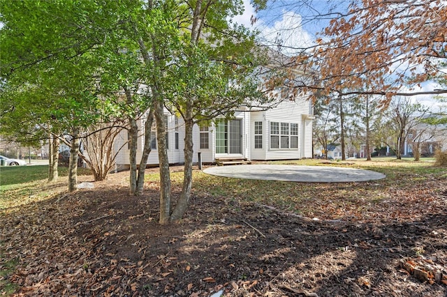 view of yard featuring entry steps and a patio