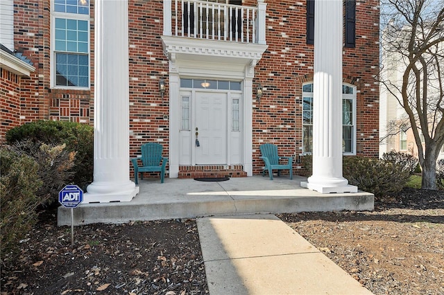 view of exterior entry with brick siding